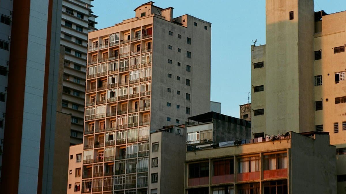 A low angle view of urban buildings with diverse architectural styles at sunset.
