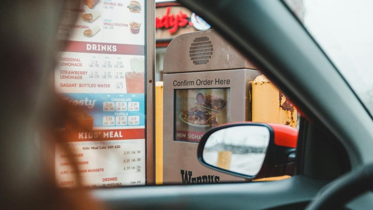 A customer interacts with a drive-thru menu to order fast food conveniently from their car.
