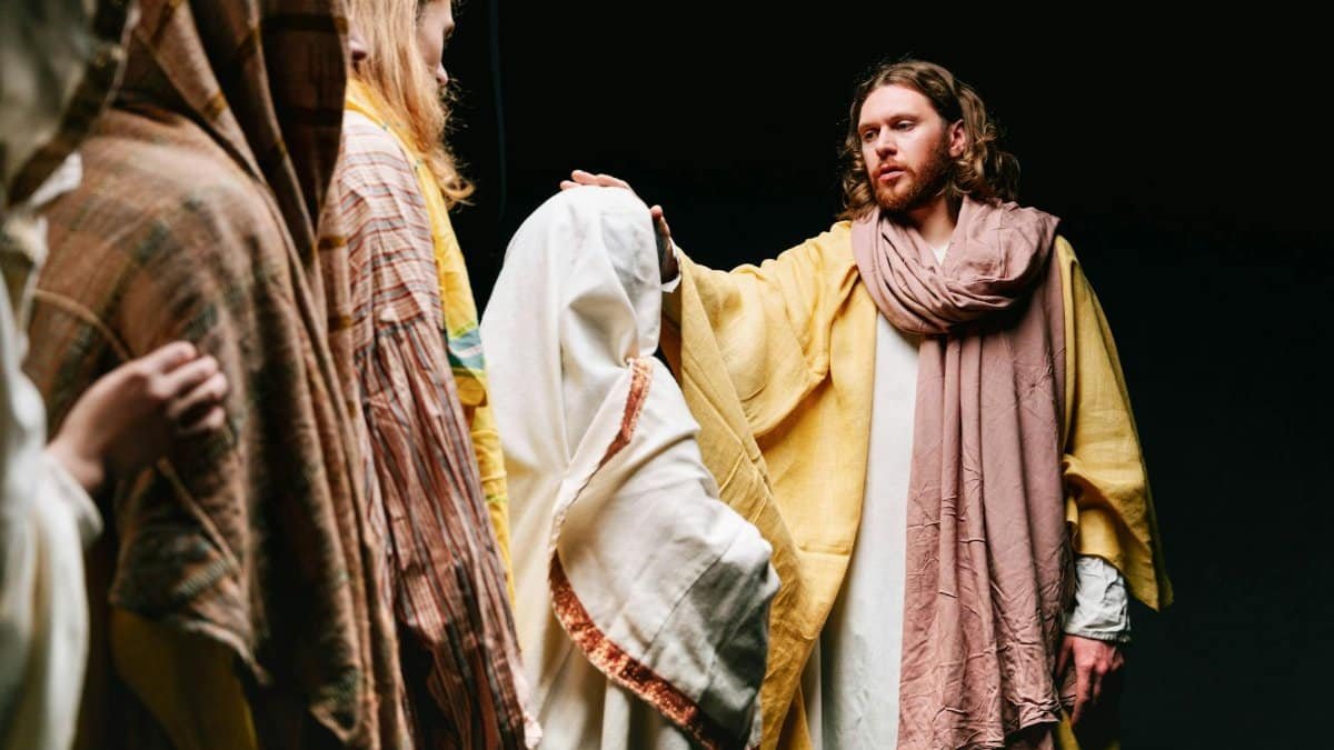 A dramatic biblical reenactment featuring Jesus among followers, conveying spirituality and faith.