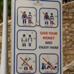 Public notice sign displaying fines for specific actions in Hvar, Croatia.
