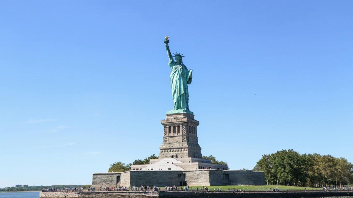 Iconic Statue of Liberty on sunny day in New York City, symbol of freedom and democracy.