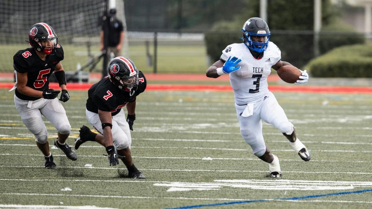 Dynamic action shot of an American football player evading opponents on a grassy field during a match.