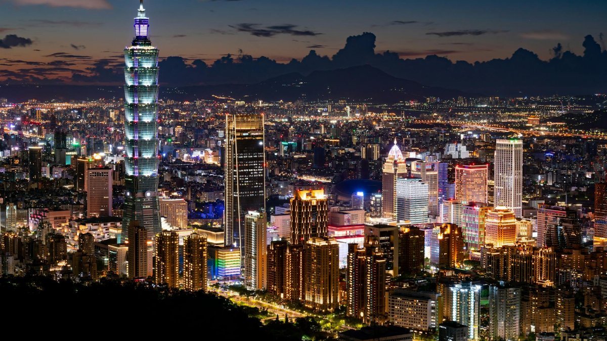 A stunning night view of Taipei showcasing the iconic Taipei 101 and shimmering city lights.