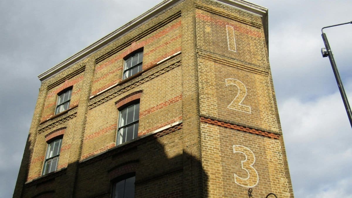 Historic London building with numbered facade and classic architecture in sunlight.
