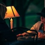 A mysterious tarot reading session between a fortune teller and a woman at night.
