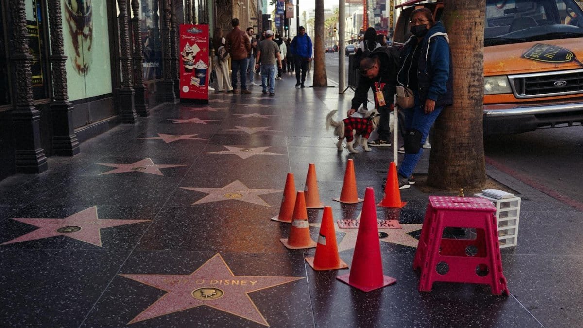 Vibrant day on the Hollywood Walk of Fame with stars and pedestrians.