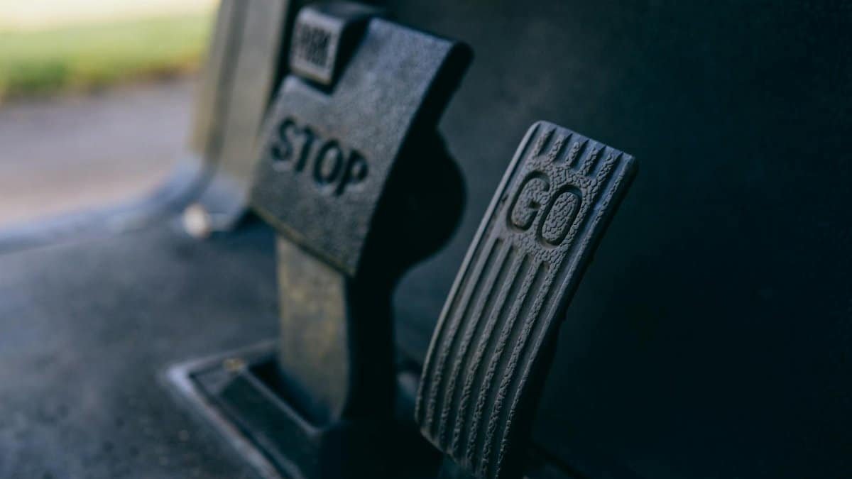 Close-up photograph of Go and Stop pedals in a vehicle, highlighting texture.