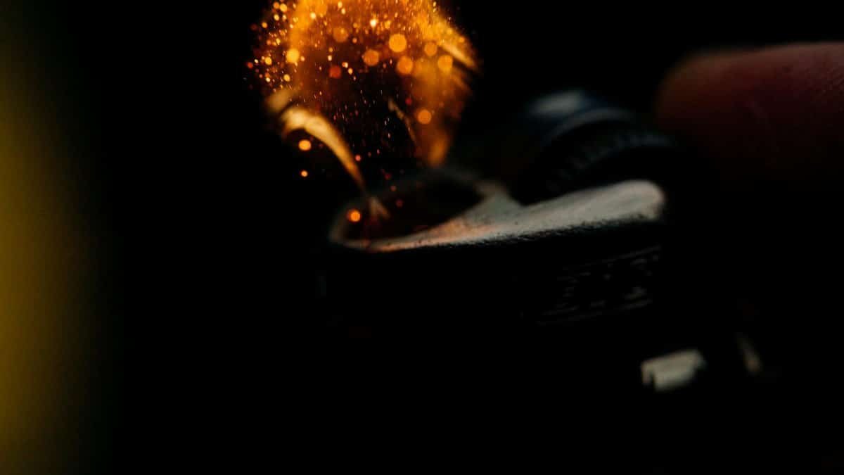 A detailed close-up of sparks igniting from a lighter, capturing the heat and fire ignition moment.