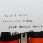 Vintage typewriter conveying message on social media's impact on mental health.