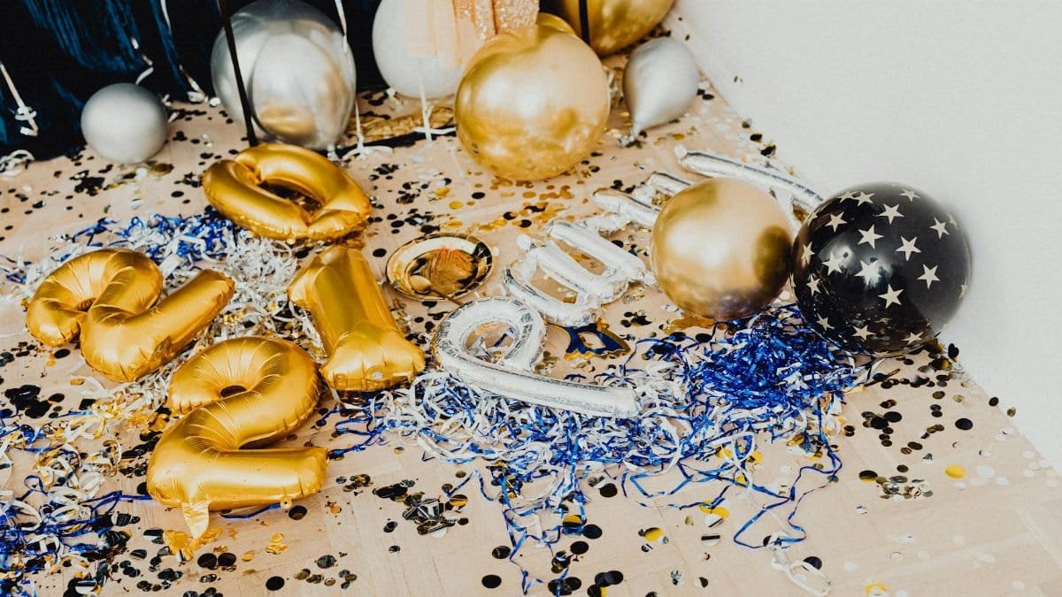 Colorful balloons and confetti scattered on the floor, perfect for a festive New Year's celebration.