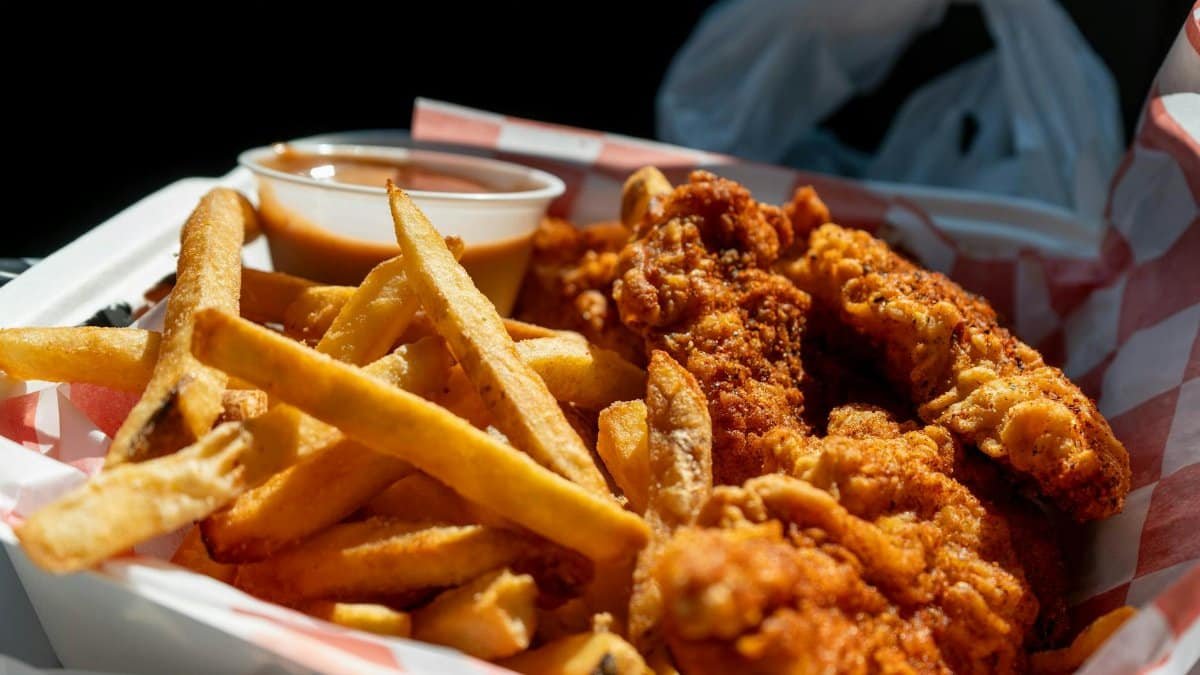 Delicious serving of crispy fried chicken with fries and dipping sauce in Holland, Michigan.