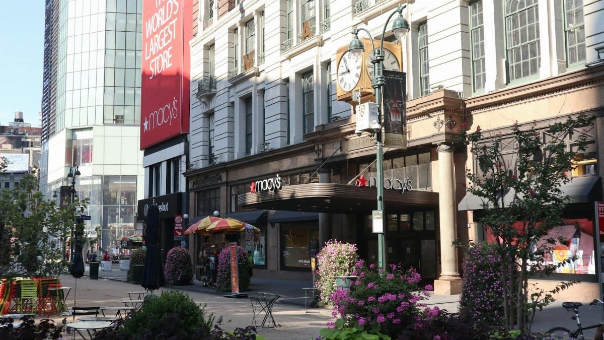 Daytime view of Macy's storefront in New York City, showcasing urban architecture and bustling streets.