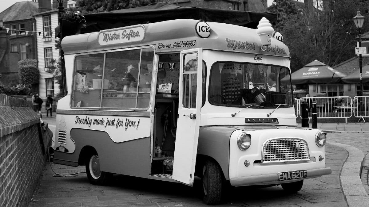 Black and white photo of a classic ice cream van parked in Rochester, England.