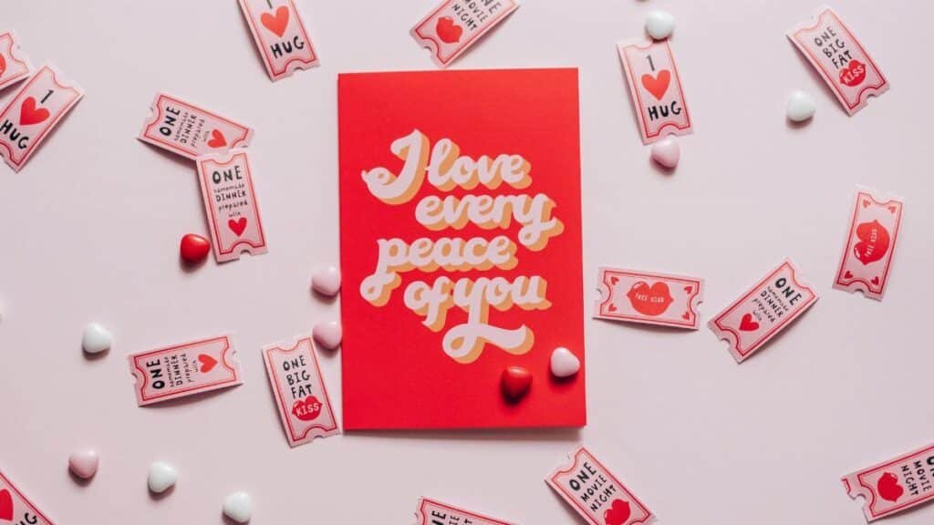 A romantic card with love tokens on a pink background, perfect for Valentine's Day.