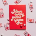A romantic card with love tokens on a pink background, perfect for Valentine's Day.