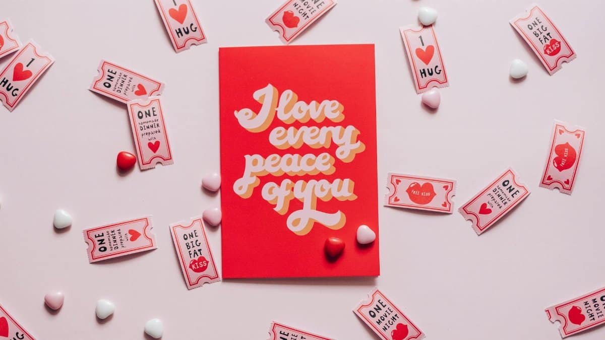 A romantic card with love tokens on a pink background, perfect for Valentine's Day.