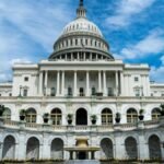 Exterior view of the iconic US Capitol Building on a sunny day in Washington, DC.