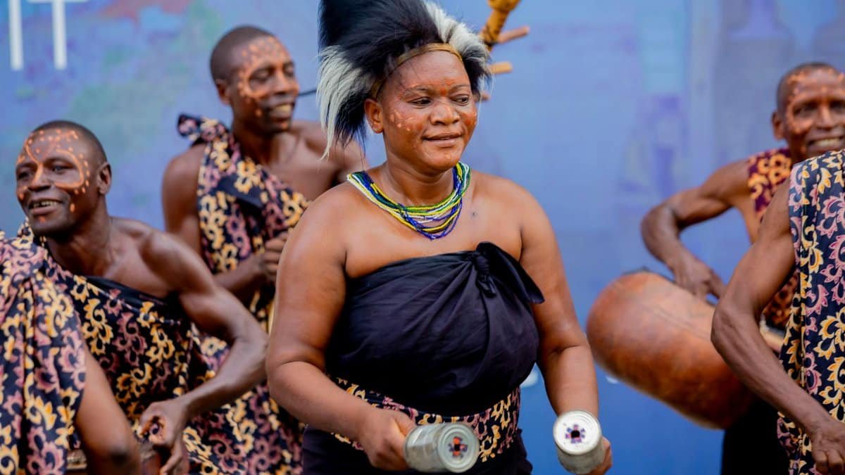 Vibrant traditional African dance performance featuring dancers in cultural attire and body paint.