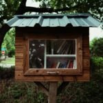 Rustic outdoor little free library surrounded by lush greenery, perfect for community sharing.
