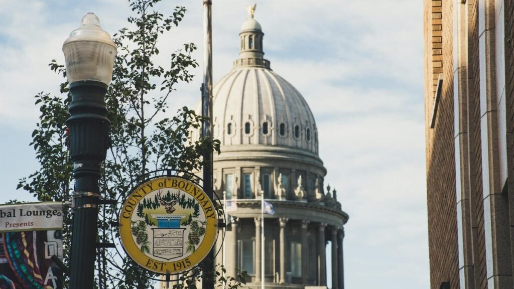 Iconic dome of Boundary County Courthouse set against clear sky, with street sign in foreground.