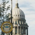 Iconic dome of Boundary County Courthouse set against clear sky, with street sign in foreground.