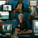 Group of teenagers enjoying retro video games with vintage monitors in an arcade setting.