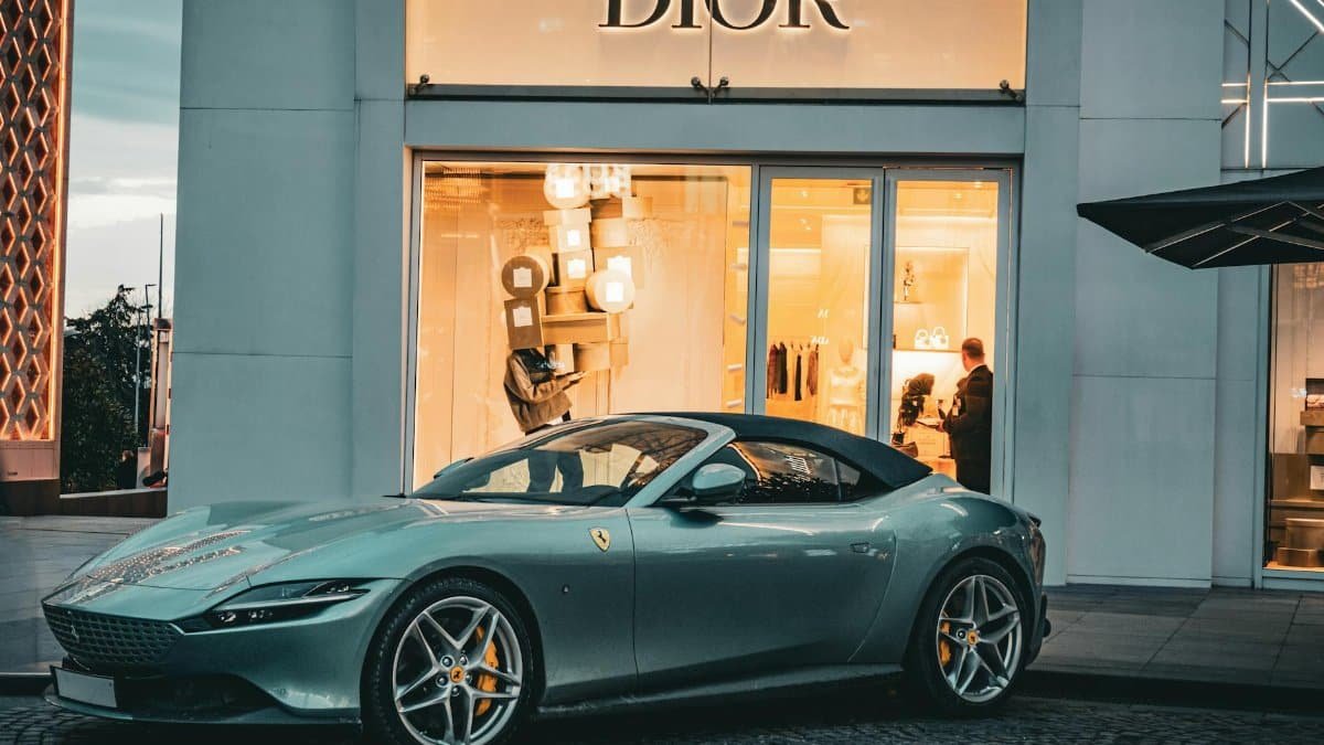 A sleek Ferrari parked in front of a Dior store in Istanbul, capturing a blend of luxury and elegance.