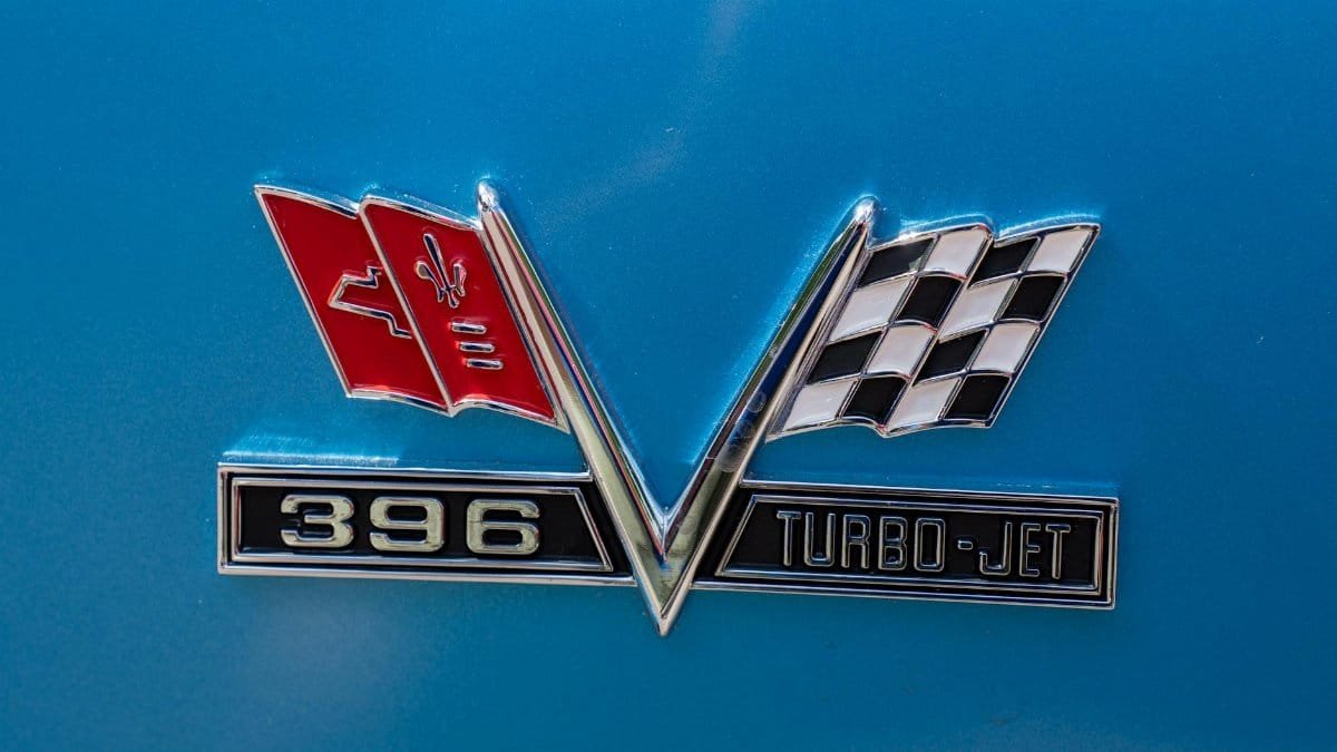 Close-up of a classic car emblem featuring a 396 Turbo-Jet badge on a blue background.