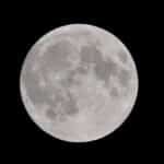 Stunning full moon against a dark night sky, showcasing captivating lunar details.