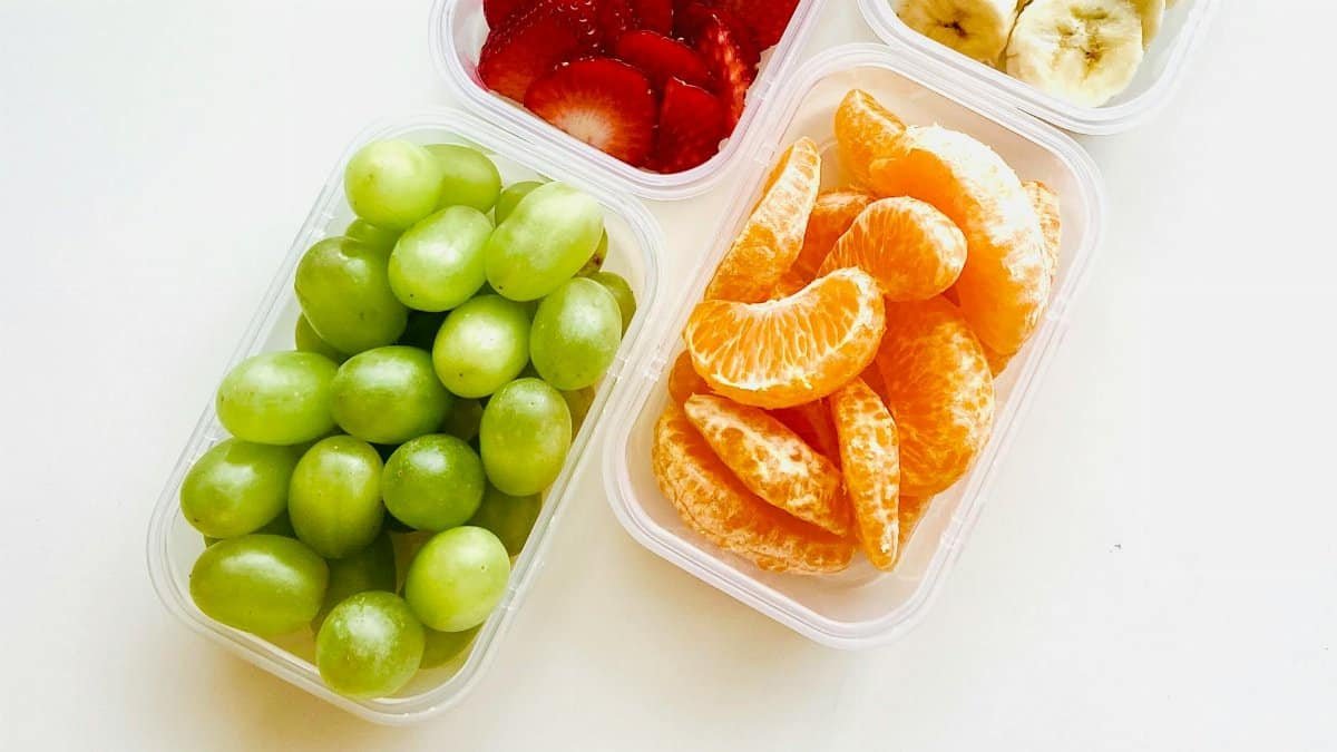 Bright and fresh fruits in containers, ideal for a healthy snack or meal prep.