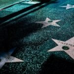 Night view of Hollywood Walk of Fame stars showcasing celebrity names and iconic design.