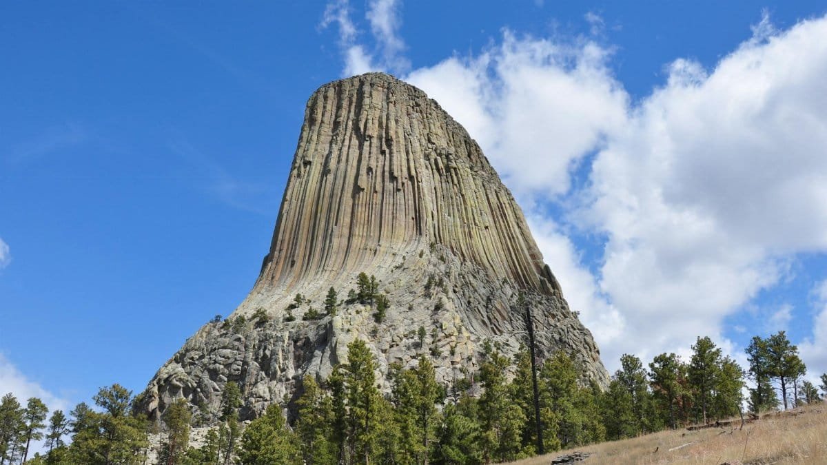 Stunning landscape of Devils Tower, Wyoming, USA with clear skies and rocky formations.