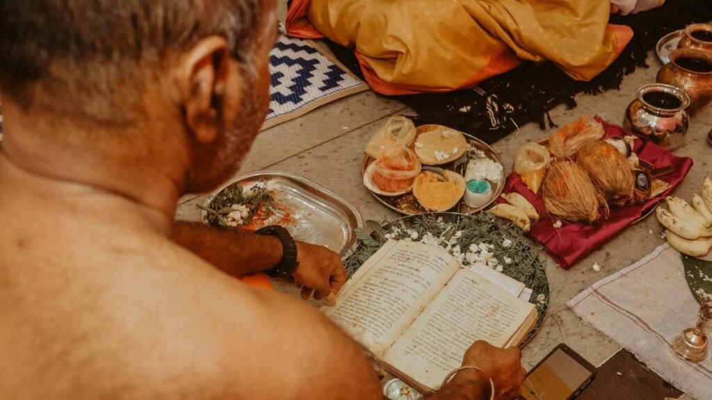 An intimate view of a traditional ceremony with ritual offerings and sacred texts.