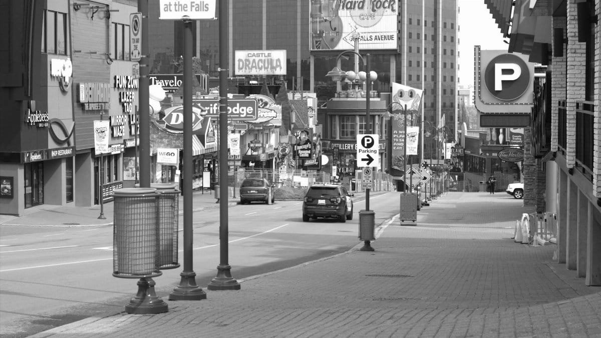 Black and white view of Clifton Hill in Niagara Falls, showing vacant streets and iconic landmarks.