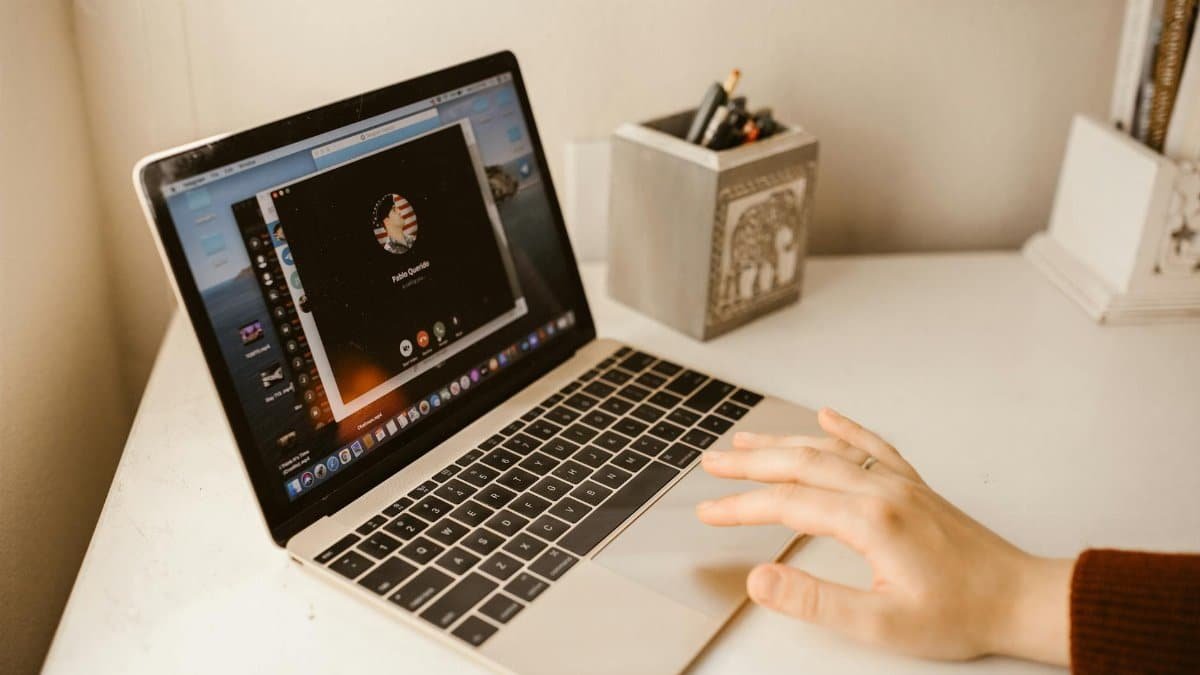 Close-up of a person making a video call on a laptop, showcasing modern communication technology.