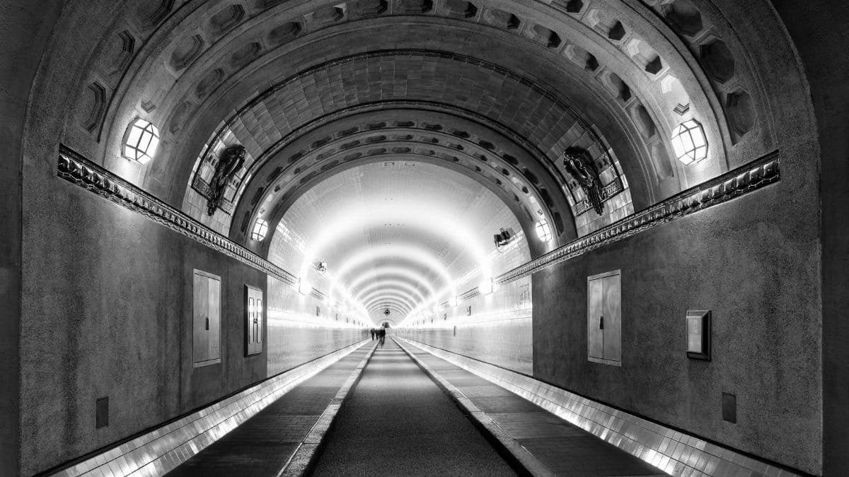 Black and white view of the historic Elbe Tunnel in Hamburg, emphasizing its architectural beauty.