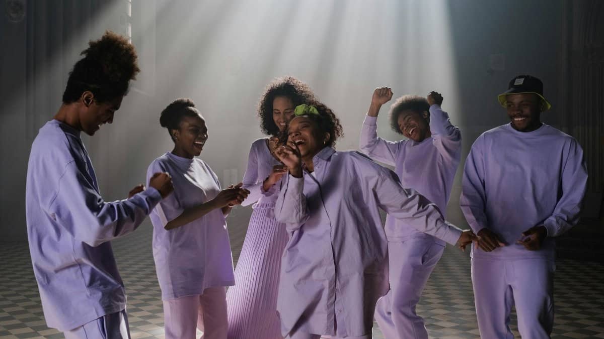 A lively group enjoying singing and dancing under sunbeams in a church setting. Vibrant and harmonious.