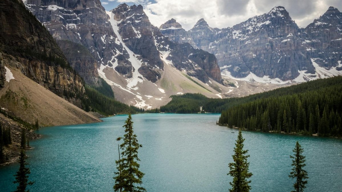 Stunning view of Moraine Lake surrounded by the Canadian Rockies and lush evergreen forests.