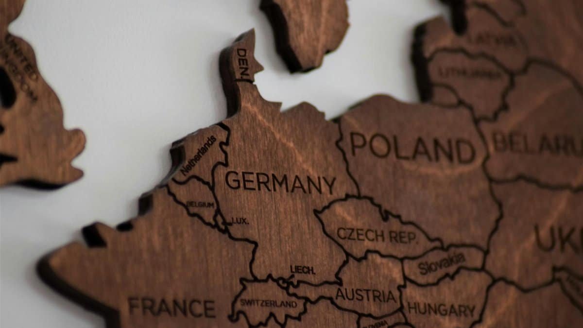 Detailed wooden map of Europe highlighting countries like Germany and Poland.