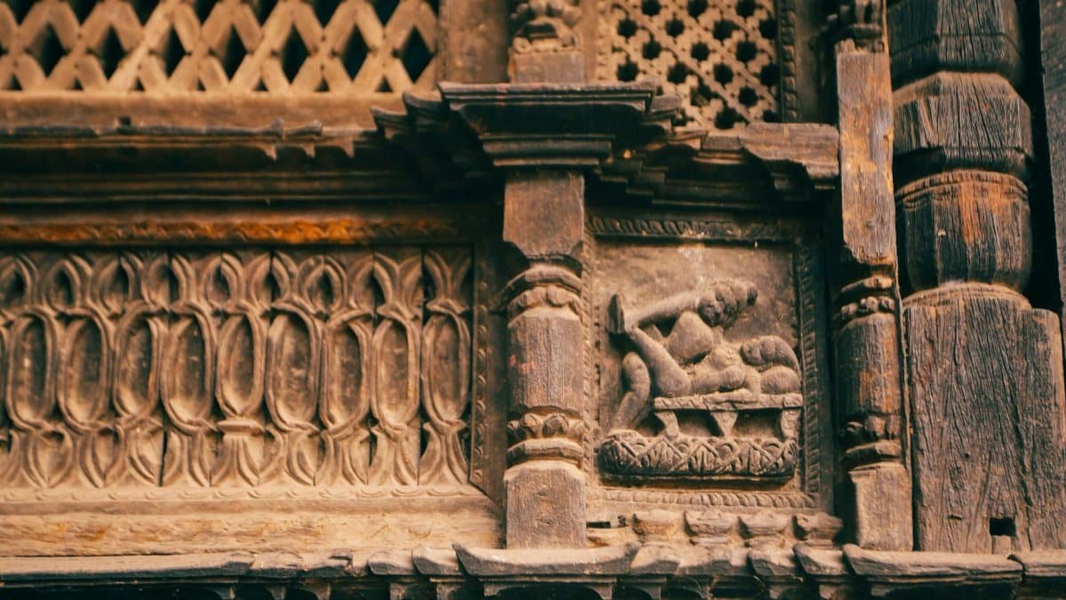 Detailed bas-relief carving on an ancient facade showcasing Pre-Columbian art.