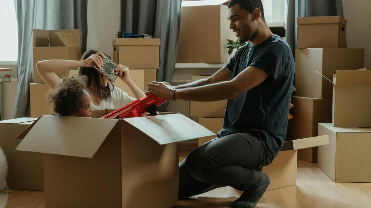A family creatively makes unpacking fun with playful activities during their move into a new home.
