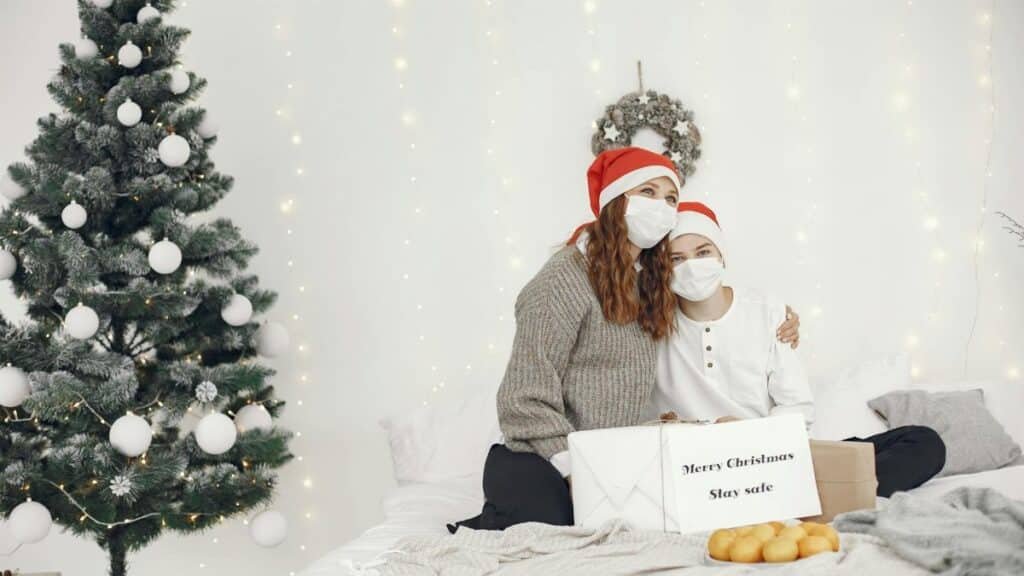 A mother and son wearing masks celebrate Christmas with safe and joyful togetherness.