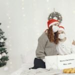 A mother and son wearing masks celebrate Christmas with safe and joyful togetherness.