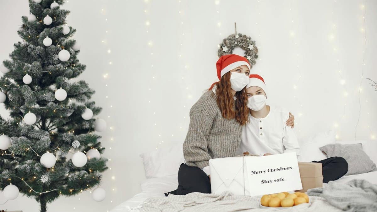 A mother and son wearing masks celebrate Christmas with safe and joyful togetherness.
