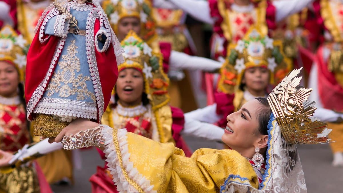 Vibrant Kuraldal Festival with traditional attire and statue of Saint Lucy.