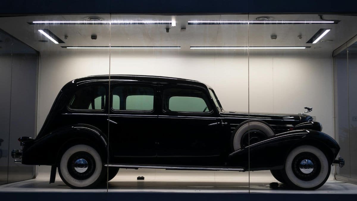 A classic vintage car on display in a museum exhibit, showcasing timeless automotive design.