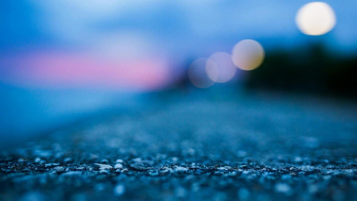 Abstract blurred view of a concrete surface with bokeh lights at twilight.