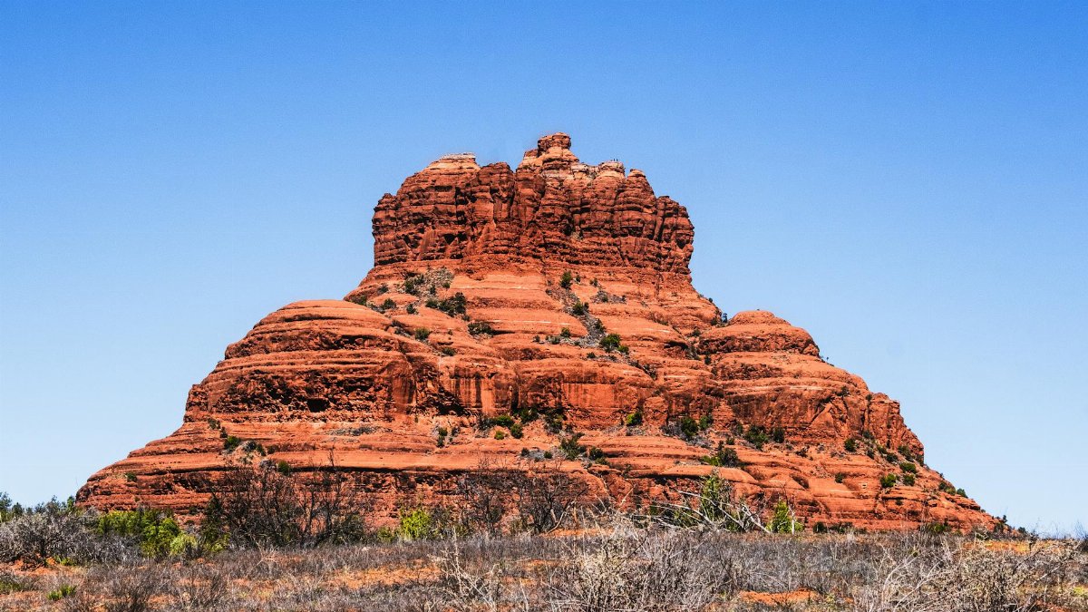 Captivating view of Bell Rock's iconic red rock formations in Sedona, Arizona's desert landscape.