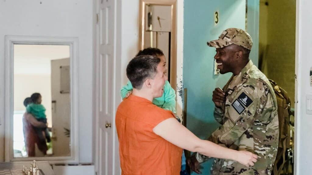 Heartwarming moment of a military family reunion as a soldier returns home.