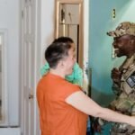 Heartwarming moment of a military family reunion as a soldier returns home.